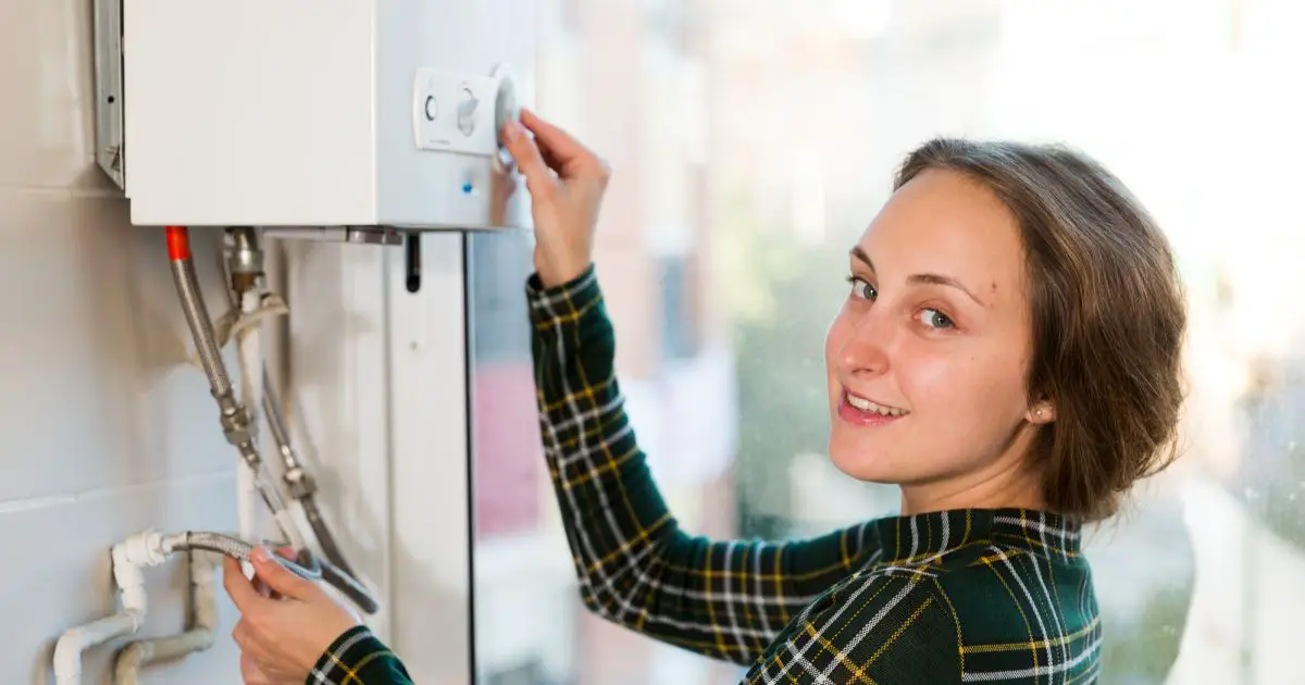 Woman adjusting water heater