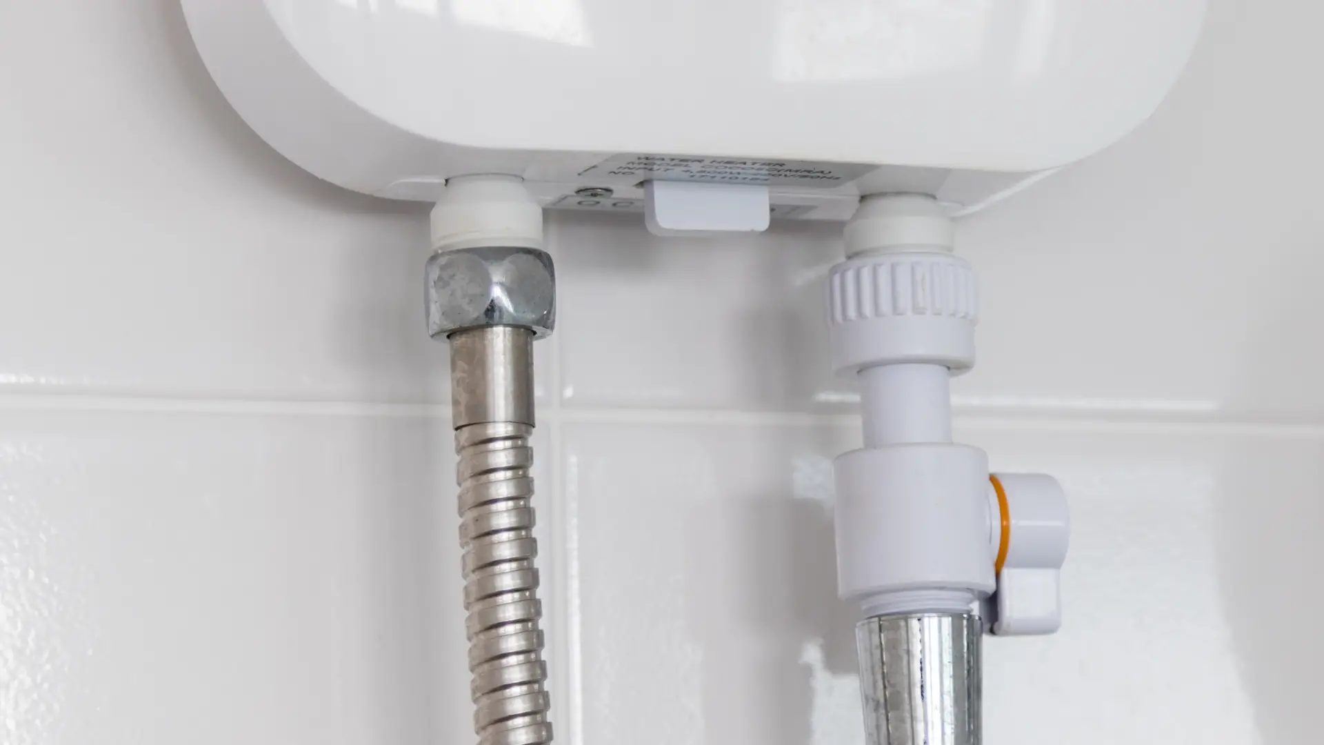 Water inlets and outlets to a white tankless water heater